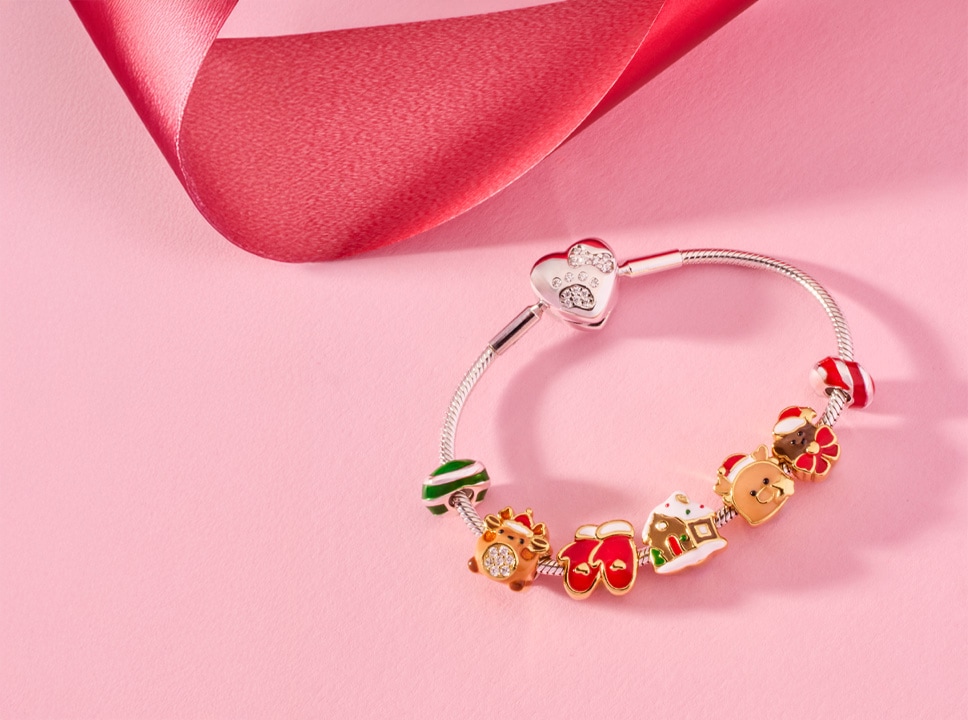 Silver beaded bracelet with Christmas pendants: reindeer, mittens, house, reindeer, teddy bear